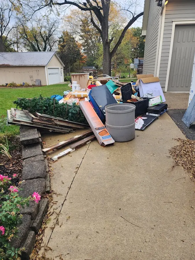 Dumpster being loaded with debris for Estate Cleanout Dumpster Rental in Porter